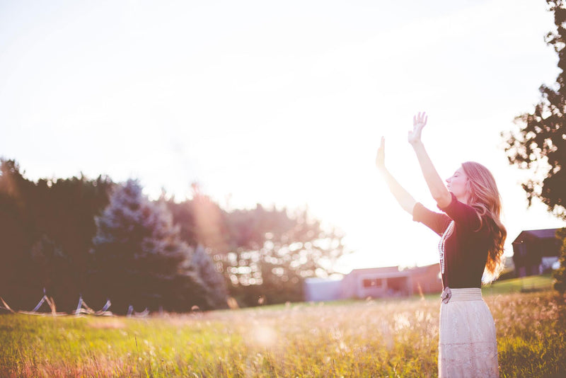 Femme au soleil dans un pré